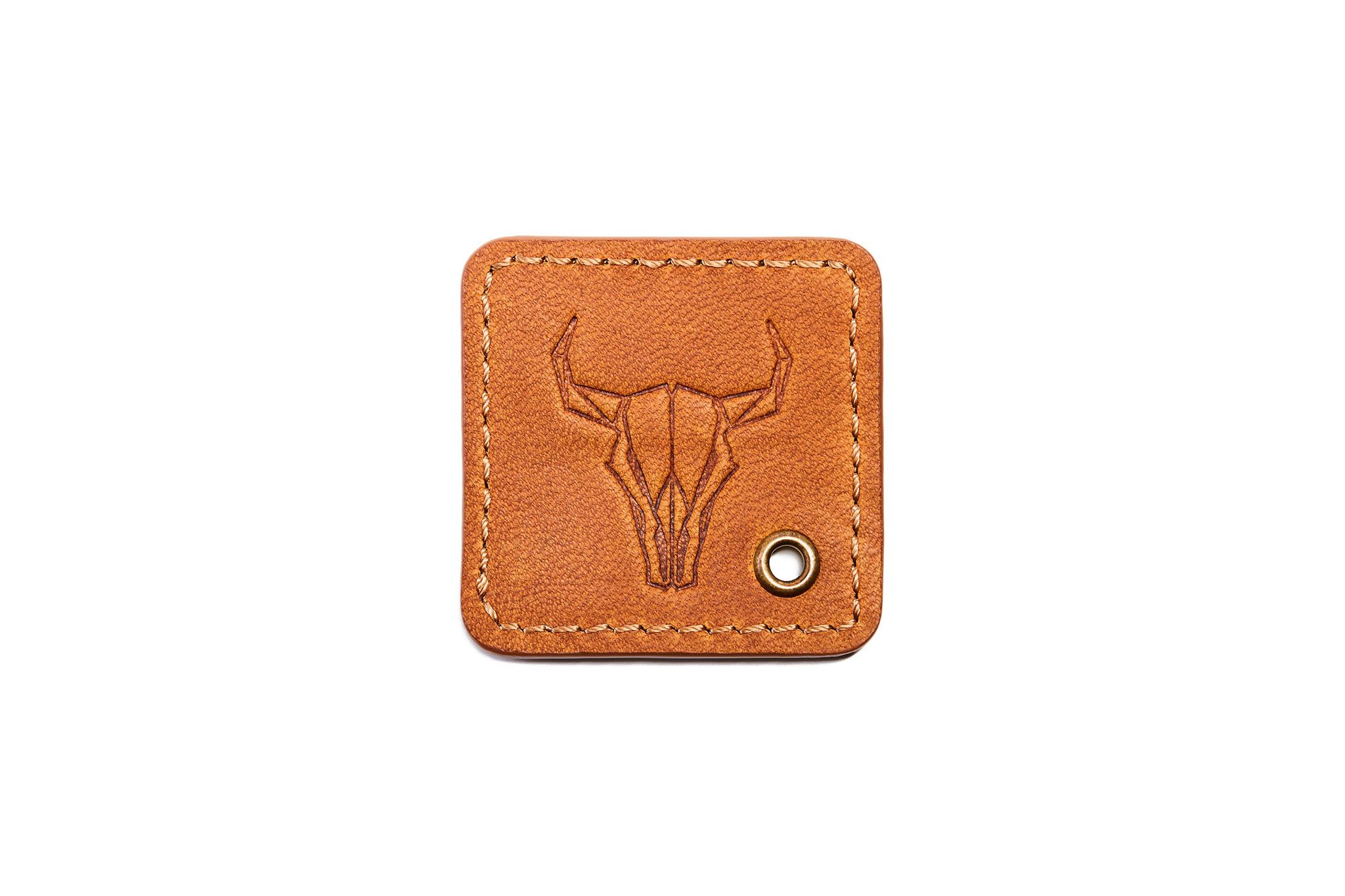 A tan leather keytag