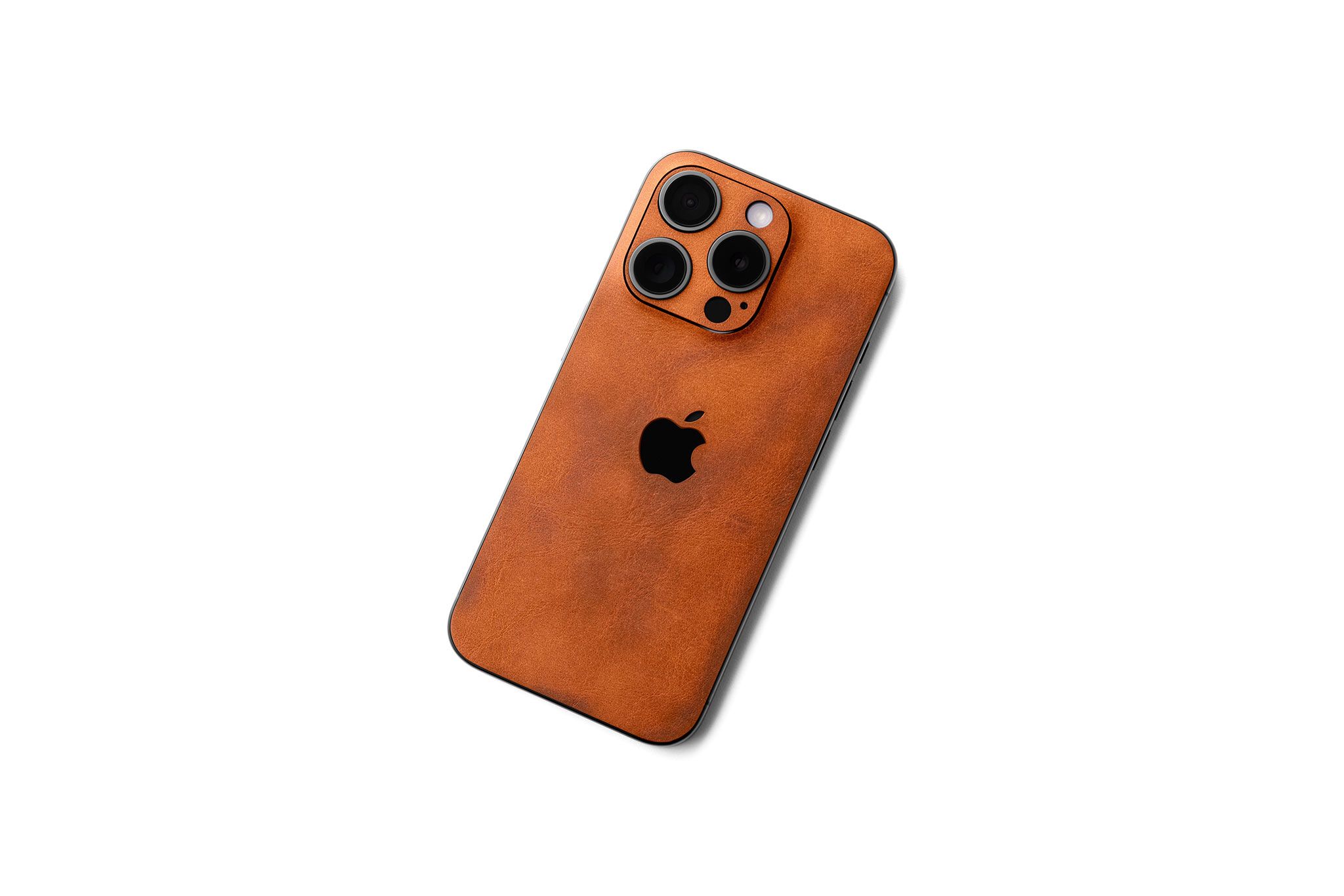 Tan leather skin on an iPhone with a light patina